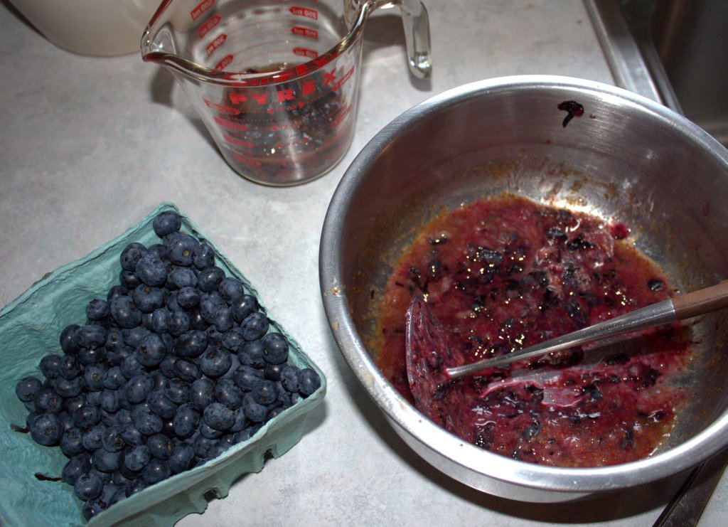 A potato masher was used to mash blueberries a cup at a time.